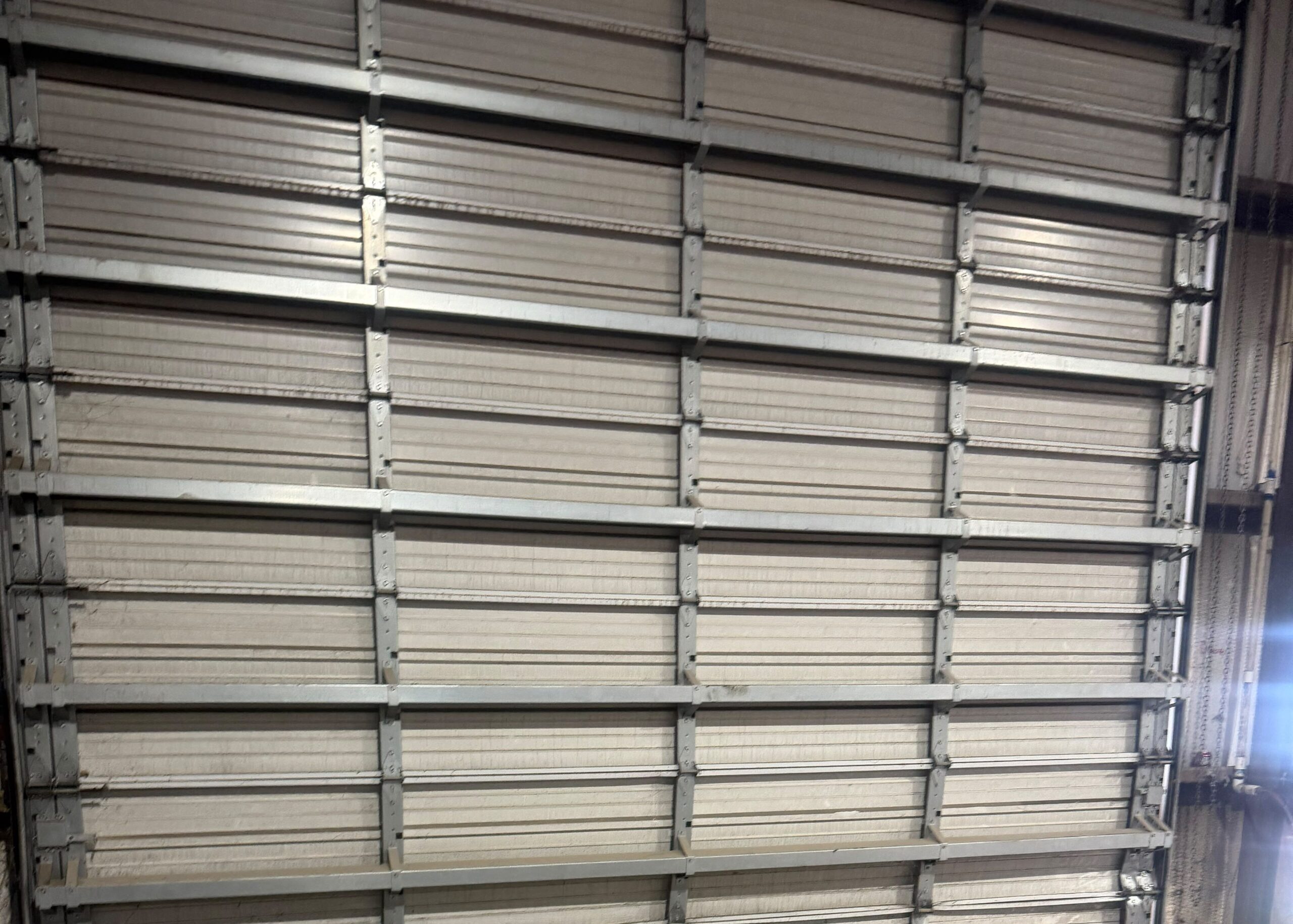 Professional commercial garage door repair for a large industrial overhead door