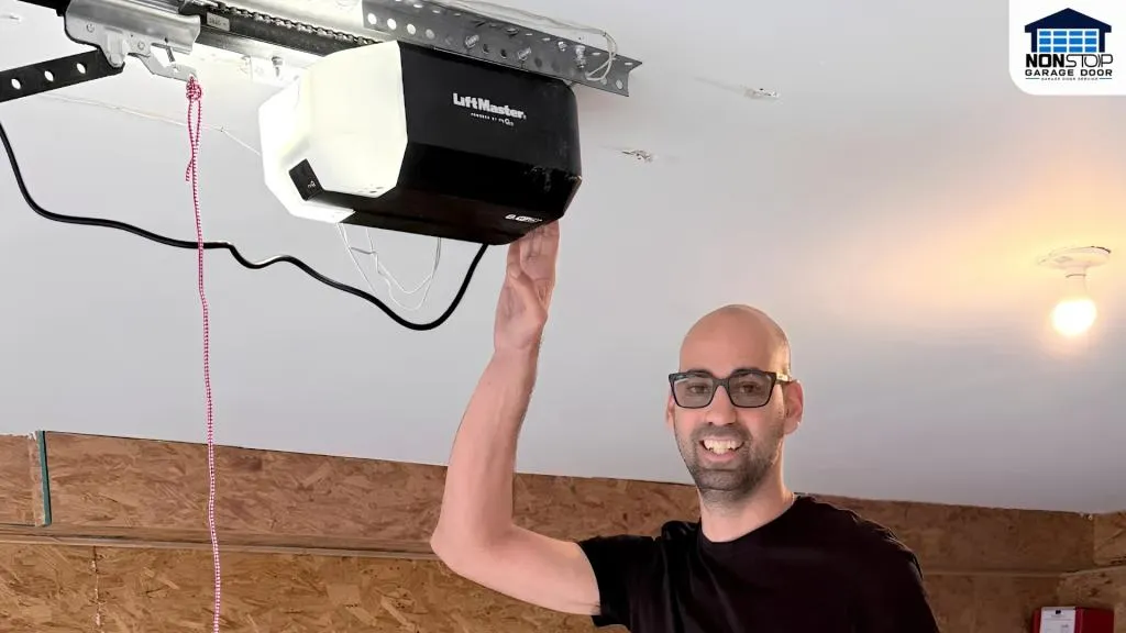 Non Stop Garage Door technician inspecting a LiftMaster garage door opener mounted on the garage ceiling during a repair service in Houston, Texas