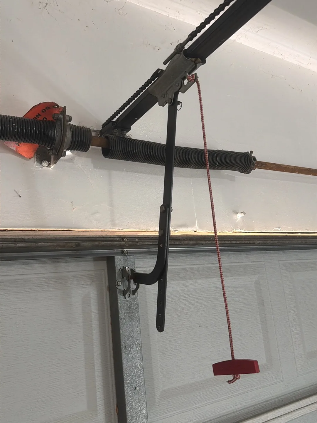 Broken garage door torsion spring before replacement in Houston TX by Non Stop Garage Door
