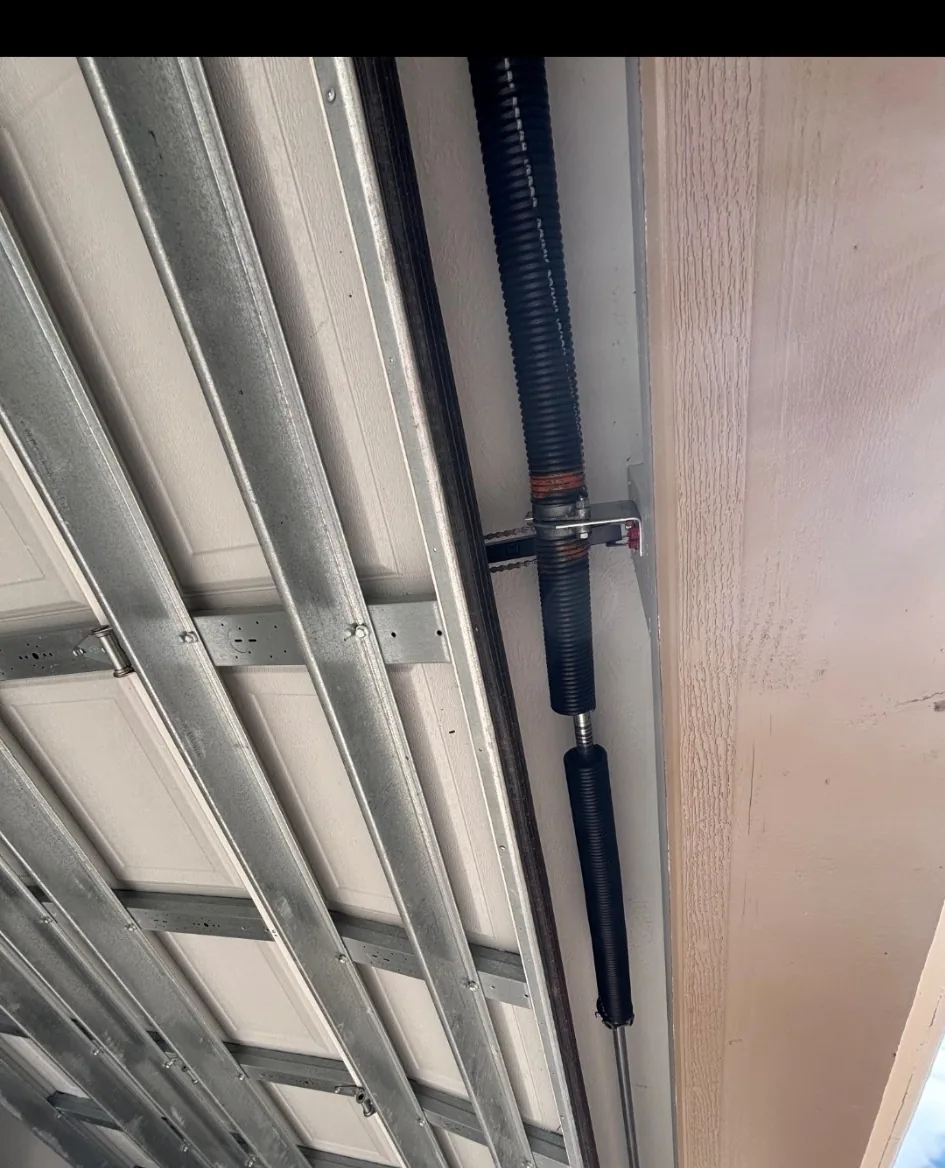 Broken torsion spring related to garage door cable system in Houston TX
