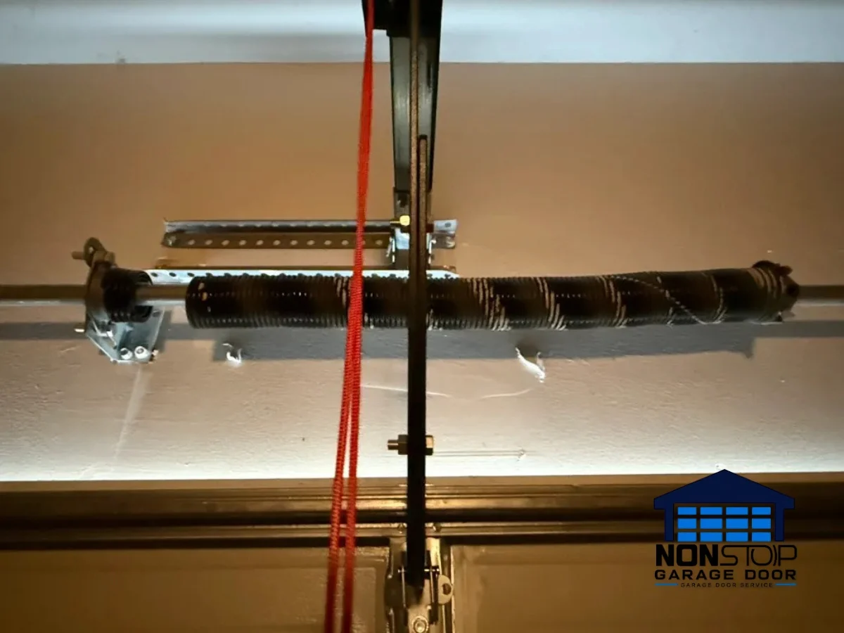 Garage door torsion spring system repair in Houston TX by Non Stop Garage Door
