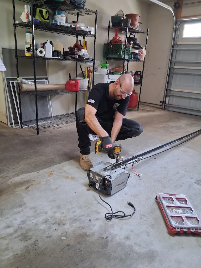 Garage door technician working on garage door hardware in Houston, TX