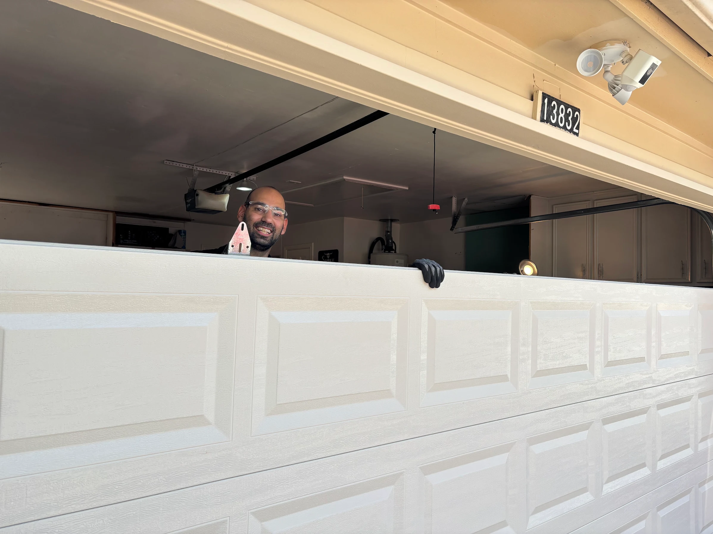 16x7 garage door installation in progress in Houston TX by Non Stop Garage Door