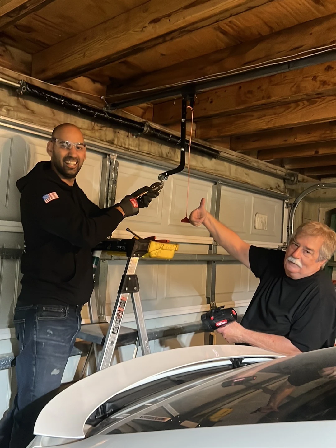 Nick performing a residential garage door repair with a homeowner in Beaumont, Texas