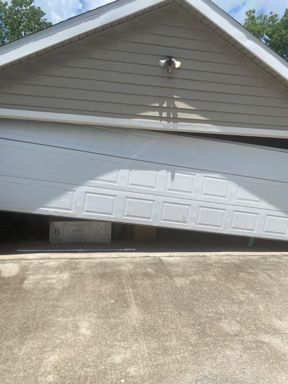 Crooked garage door off track North Houston TX before repair